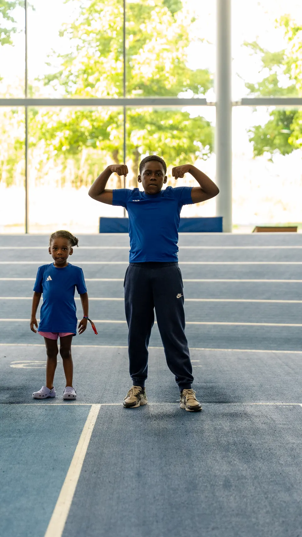 A young member and his little sister flexing on the track