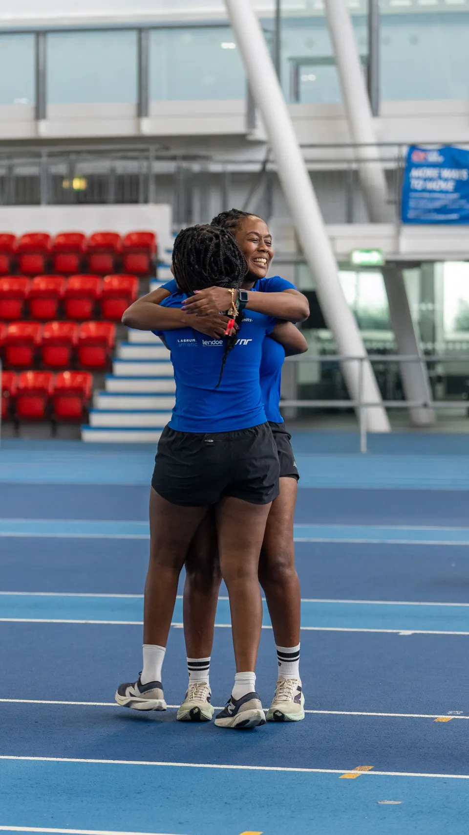 Two members embracing on the track after a race