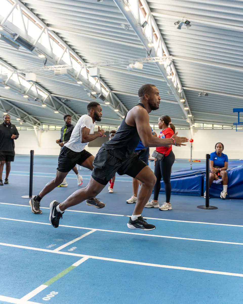 A member in full sprint over the hurdles at the Summer Games