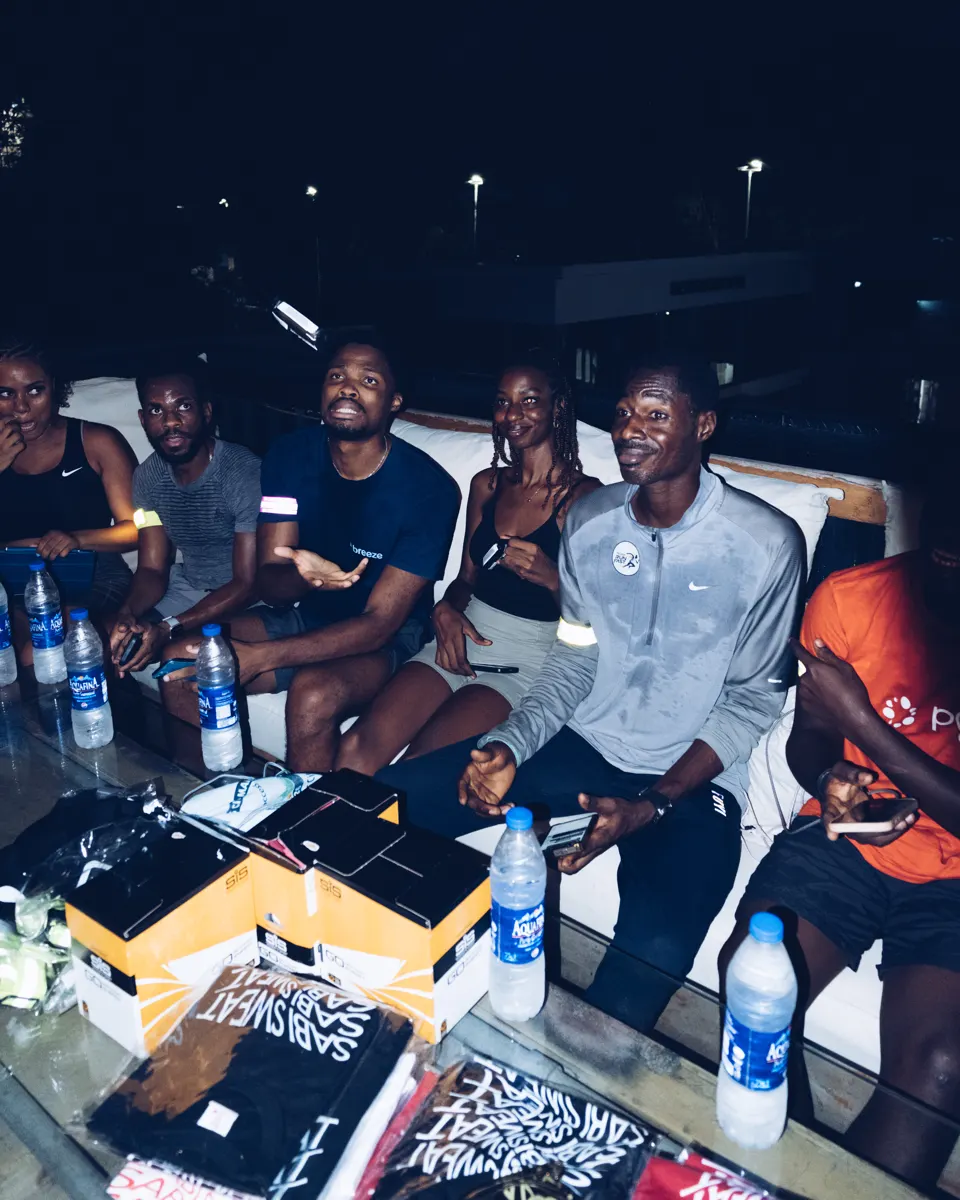 Members winding down together on a rooftop after a Lagos shakeout run