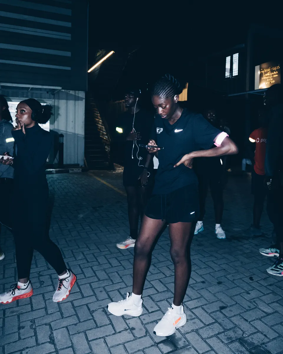 A member striding through the Lagos night on a shakeout run